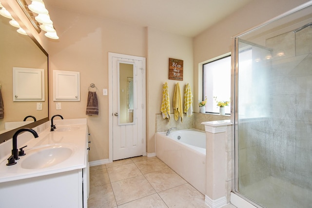 full bathroom with a stall shower, tile patterned flooring, a garden tub, and a sink