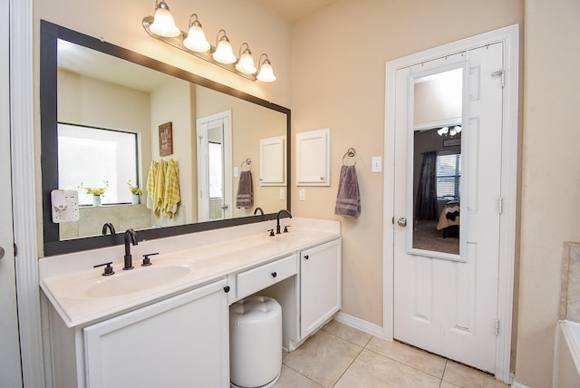 full bath with double vanity, a sink, and tile patterned floors