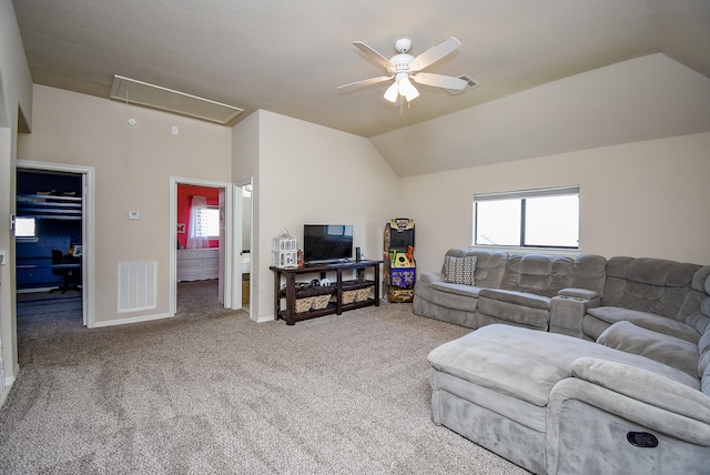 living room featuring carpet, visible vents, attic access, vaulted ceiling, and ceiling fan