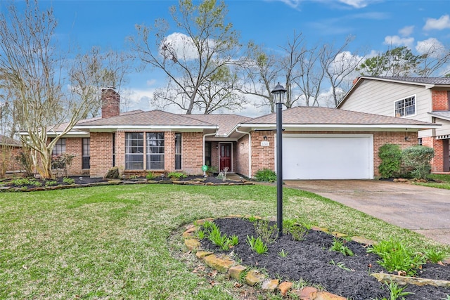 view of front facade with a garage, driveway, a chimney, a front yard, and brick siding