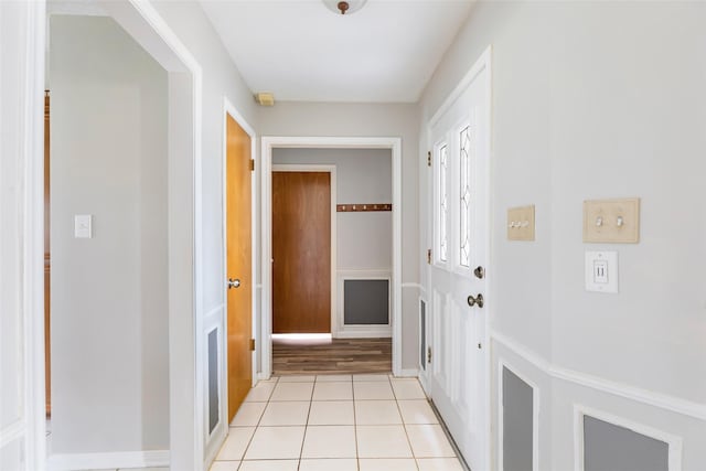 corridor featuring light tile patterned floors