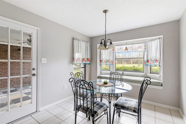 dining room with baseboards and light tile patterned flooring