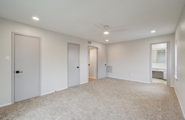 unfurnished bedroom featuring carpet, visible vents, and recessed lighting