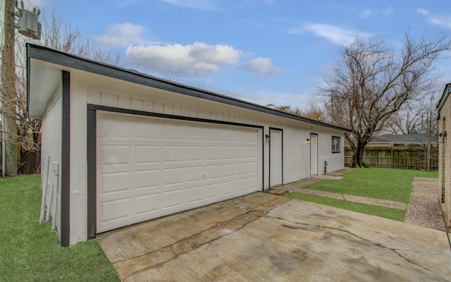 detached garage featuring fence