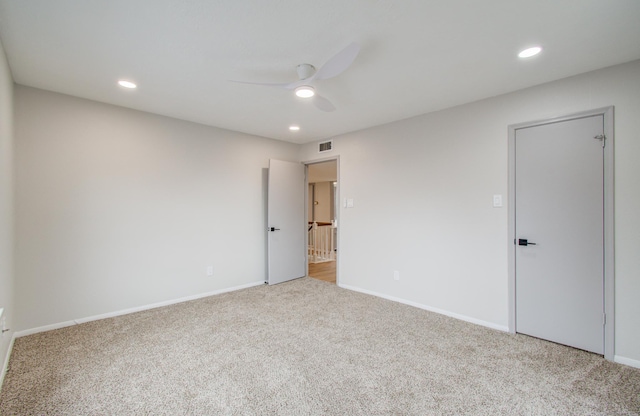 spare room featuring ceiling fan, carpet floors, visible vents, and recessed lighting