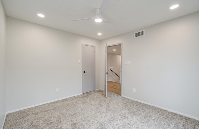 carpeted empty room featuring baseboards, visible vents, a ceiling fan, and recessed lighting