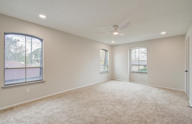 spare room featuring baseboards, carpet, a ceiling fan, and recessed lighting