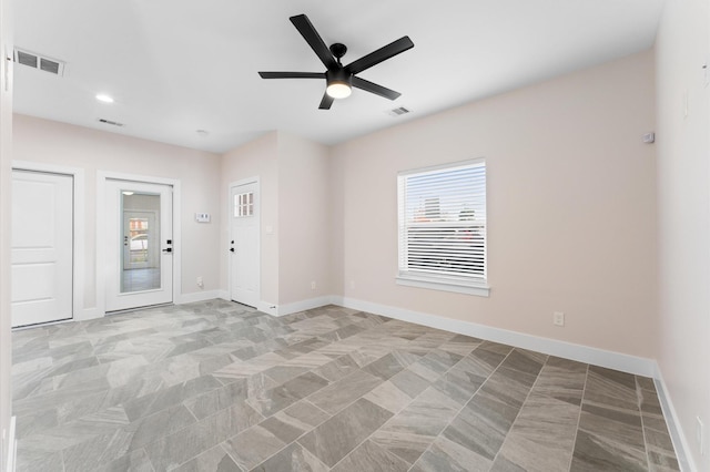 unfurnished room with visible vents, recessed lighting, a ceiling fan, and baseboards