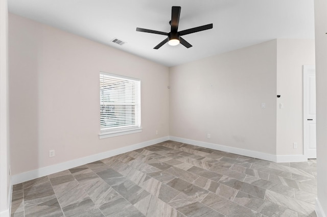 spare room featuring visible vents, baseboards, and a ceiling fan