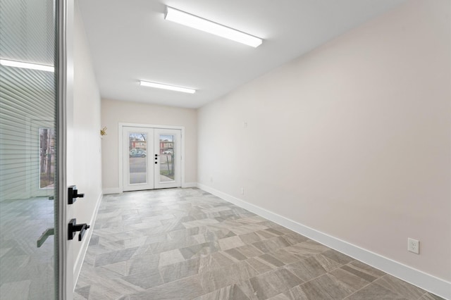 interior space with french doors and baseboards