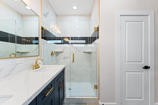 bathroom featuring a sink, double vanity, and a shower stall