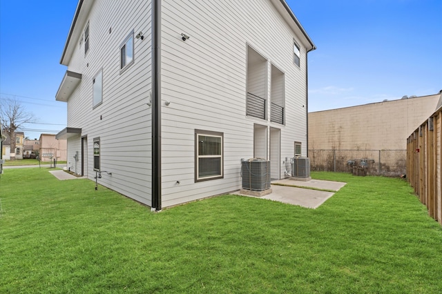 back of house featuring a yard, a patio area, central AC unit, and fence