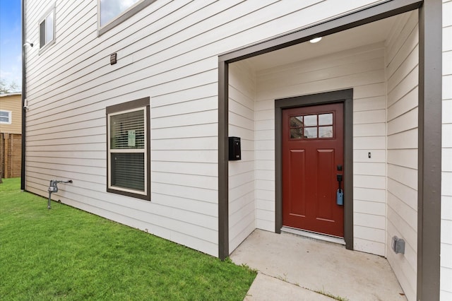 doorway to property with a yard