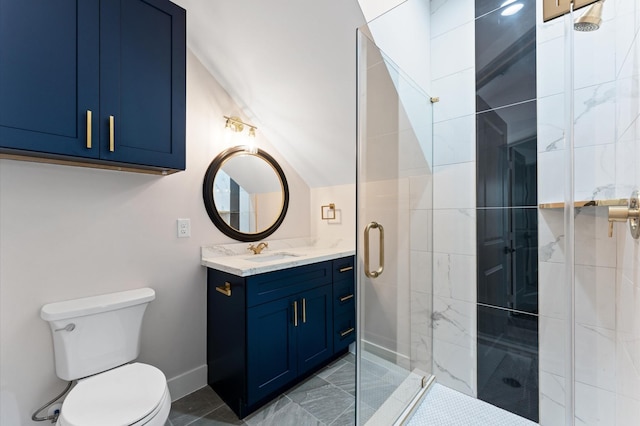 bathroom featuring vanity, a shower stall, toilet, and baseboards