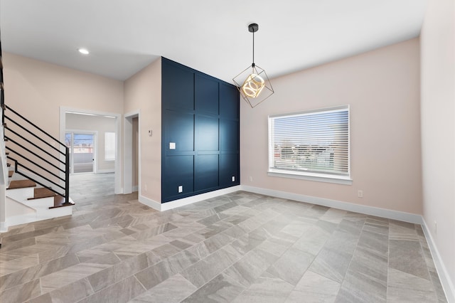 unfurnished room featuring stairs, plenty of natural light, recessed lighting, and baseboards