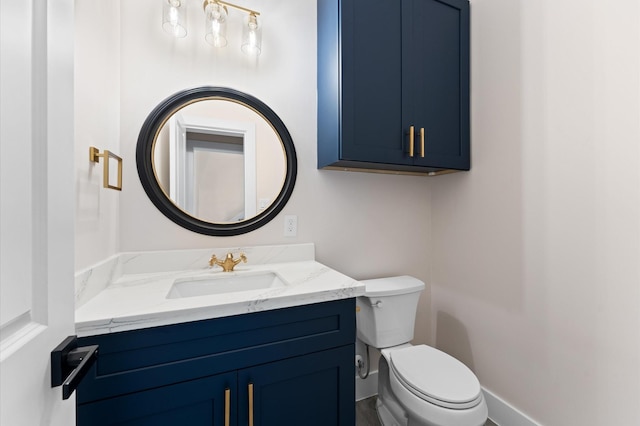 half bath featuring vanity, toilet, and baseboards