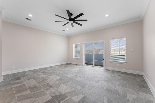 empty room with ceiling fan, visible vents, baseboards, and ornamental molding