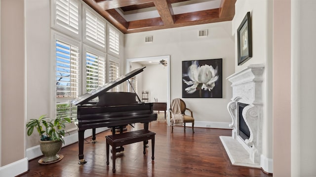 44 Tall Trl, Missouri City, TX 77459 - living area featuring dark wood-style floors, coffered ceiling, visible vents, and a fireplace