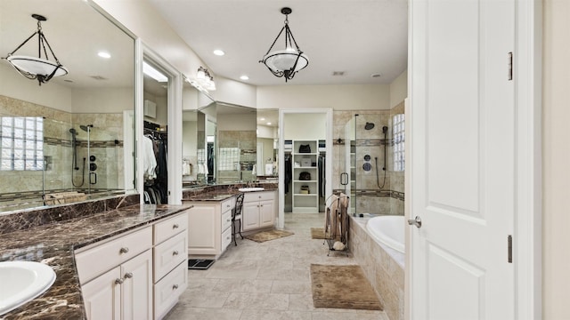 44 Tall Trl, Missouri City, TX 77459 - full bathroom featuring two vanities, a stall shower, a spacious closet, recessed lighting, and a garden tub