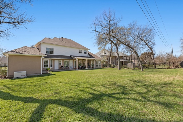 44 Tall Trl, Missouri City, TX 77459 - rear view of property with fence, a yard, and stucco siding
