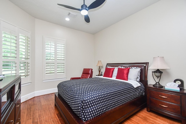 44 Tall Trl, Missouri City, TX 77459 - bedroom featuring baseboards, wood finished floors, visible vents, and ceiling fan