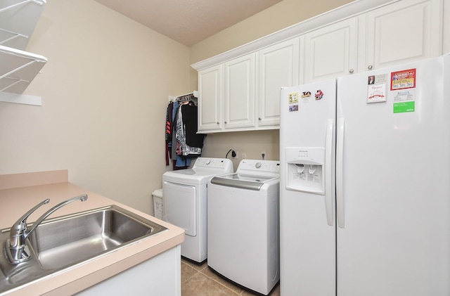 44 Tall Trl, Missouri City, TX 77459 - laundry area with washing machine and dryer, cabinet space, a sink, and light tile patterned floors