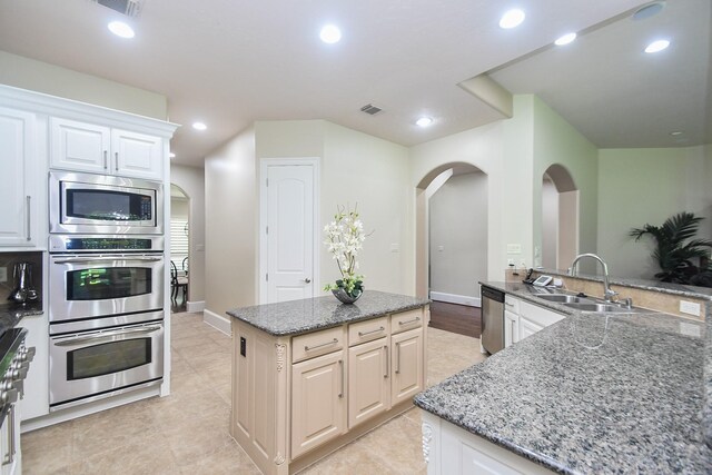 44 Tall Trl, Missouri City, TX 77459 - kitchen with recessed lighting, visible vents, a sink, arched walkways, and appliances with stainless steel finishes