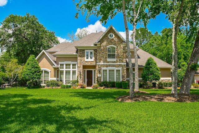 44 Tall Trl, Missouri City, TX 77459 - french provincial home featuring stucco siding, a front lawn, and stone siding