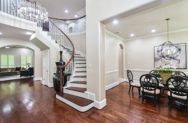 44 Tall Trl, Missouri City, TX 77459 - stairs featuring arched walkways, a chandelier, wood finished floors, and ornamental molding