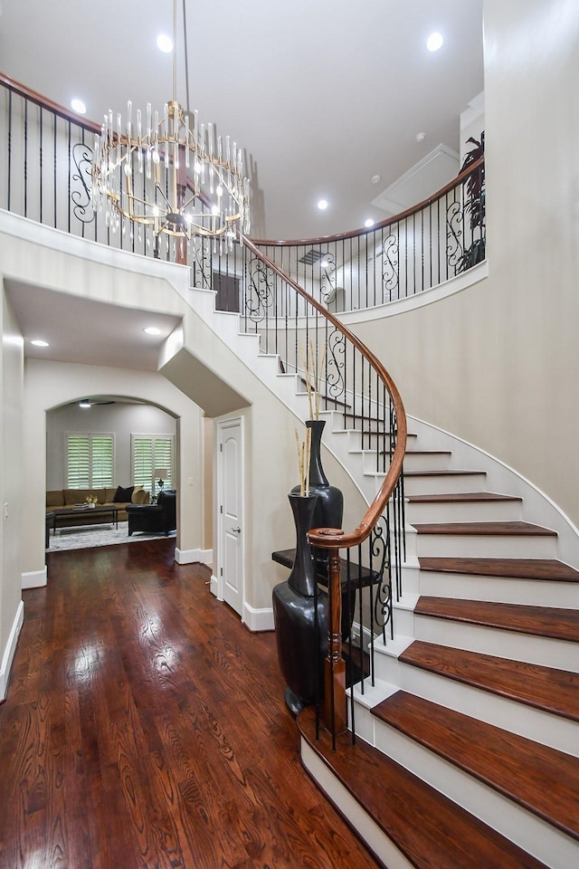 44 Tall Trl, Missouri City, TX 77459 - stairway with recessed lighting, a towering ceiling, wood finished floors, arched walkways, and baseboards