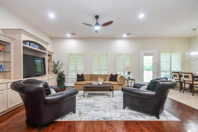 44 Tall Trl, Missouri City, TX 77459 - living area featuring dark wood finished floors, recessed lighting, visible vents, and ceiling fan with notable chandelier