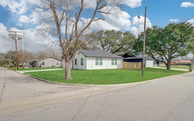 view of front of home with a front lawn, fence, and a residential view