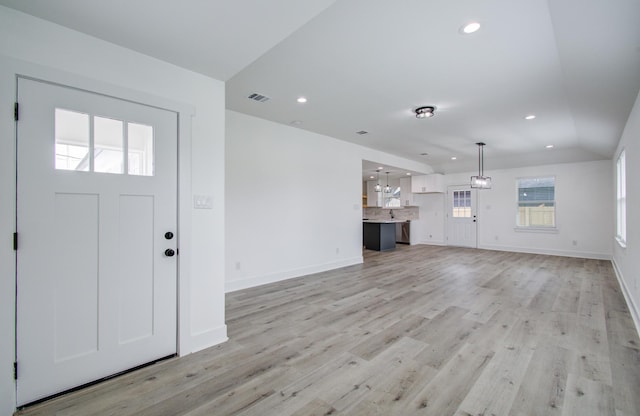 unfurnished living room featuring light wood-style floors, recessed lighting, visible vents, and baseboards