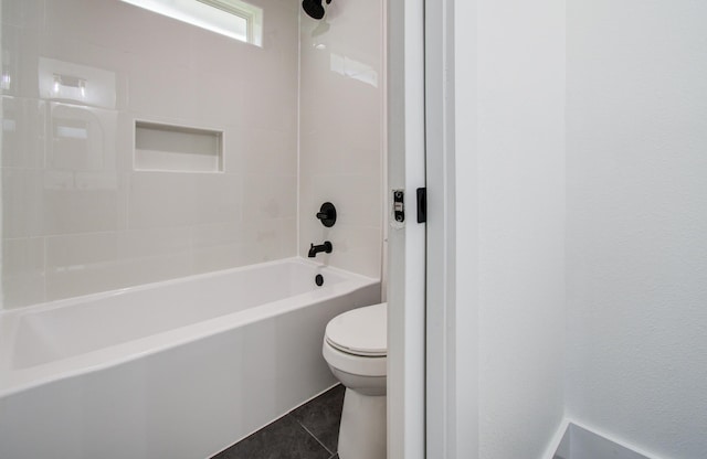 bathroom with toilet, tile patterned floors, and bathing tub / shower combination