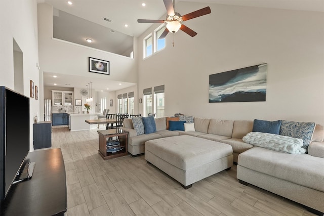 living area with light wood-style floors, visible vents, a ceiling fan, and recessed lighting