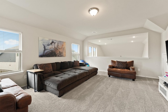 living area featuring carpet floors, lofted ceiling, visible vents, and baseboards