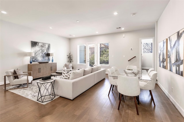 living area featuring a wealth of natural light, visible vents, wood finished floors, and recessed lighting