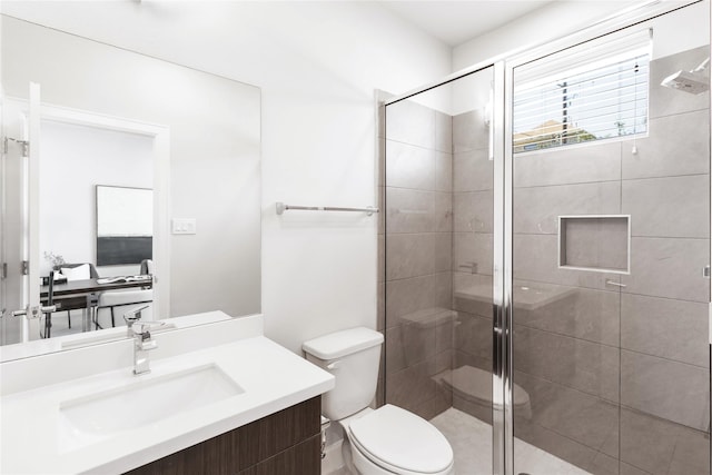 full bathroom with toilet, vanity, and a shower stall