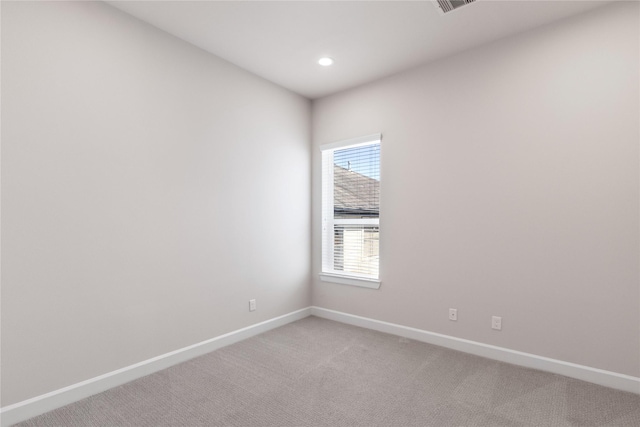 empty room with recessed lighting, visible vents, baseboards, and light colored carpet