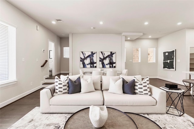 living area with baseboards, stairs, wood finished floors, and recessed lighting