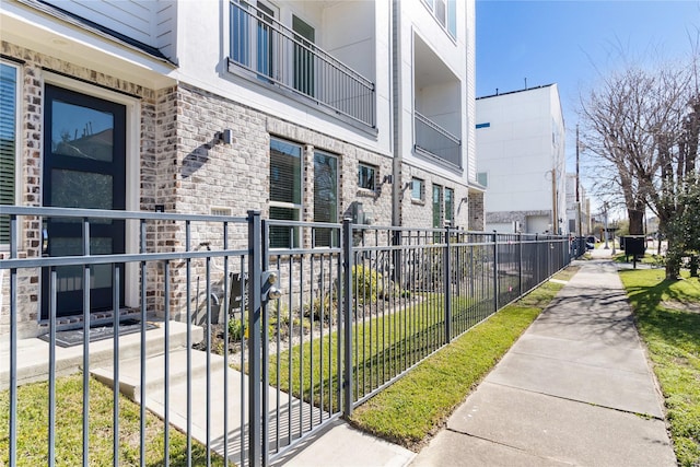 view of property's community with a residential view and fence