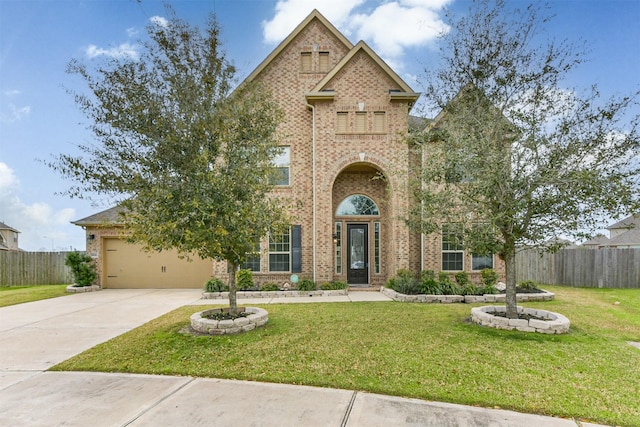 view of front of home with concrete driveway, brick siding, a front lawn, and fence