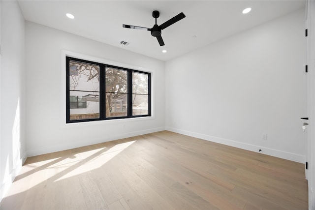 unfurnished room featuring light wood finished floors, visible vents, and recessed lighting