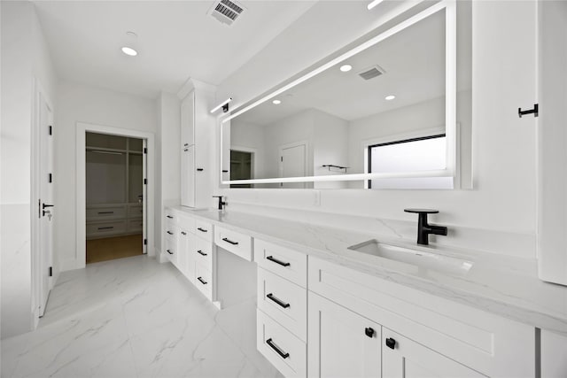 full bath featuring marble finish floor, visible vents, a sink, and double vanity