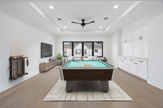 recreation room featuring a tray ceiling, billiards, visible vents, and light wood-style floors