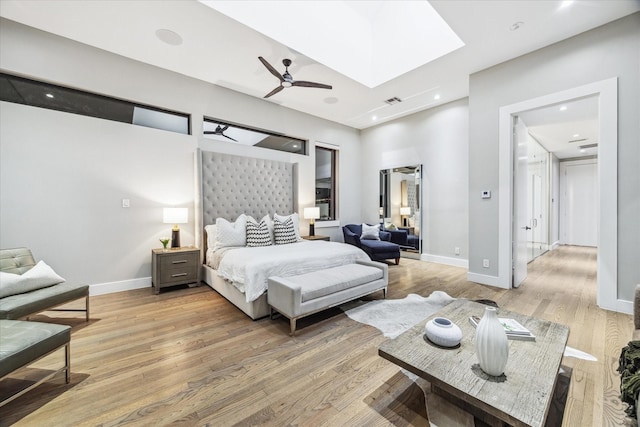 bedroom featuring a skylight, recessed lighting, visible vents, light wood-type flooring, and baseboards