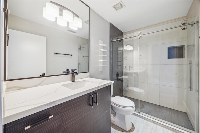 bathroom with toilet, a stall shower, visible vents, and vanity