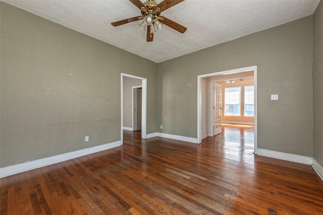 unfurnished room featuring a ceiling fan, wood-type flooring, and baseboards