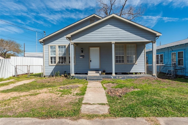 bungalow-style home featuring covered porch, fence, and a gate