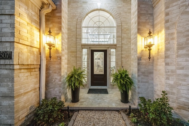 property entrance with brick siding and a porch